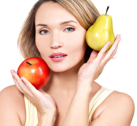 女人年轻漂亮的女人手里拿着苹果和梨子-隔离在白色上新鲜饮食维生素