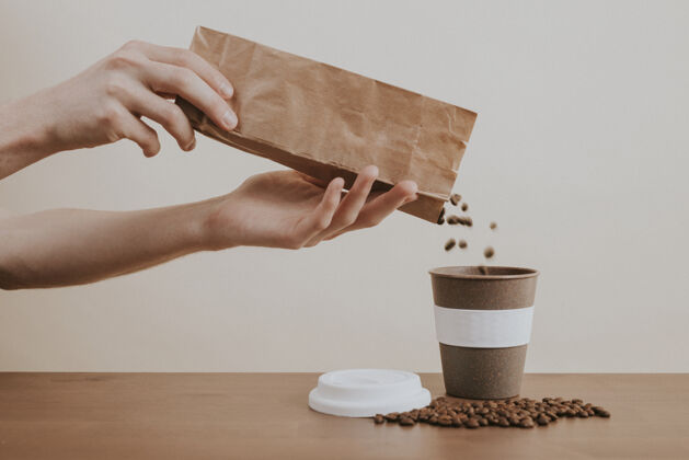 时事通讯用手把咖啡豆从纸袋倒进咖啡杯咖啡豆芳香手