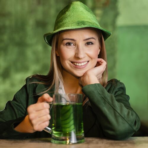 三叶草戴帽子的笑脸女人在酒吧喝酒庆祝圣帕特里克节女性帽子幸运