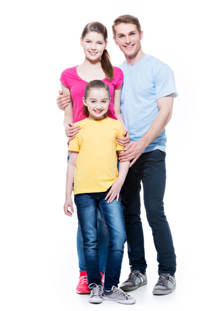 快乐一个幸福的年轻家庭的完整肖像 女儿穿着五彩衬衫-隔离在白色墙上成人吸引力快乐