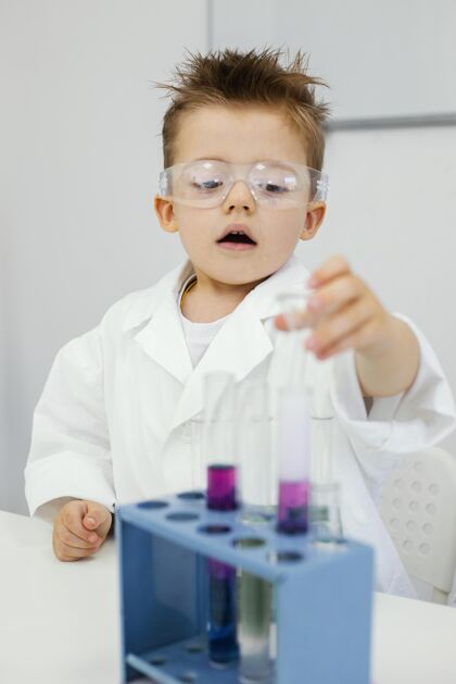 教育戴着安全眼镜的年轻科学家在实验室做实验安全眼镜青年研究