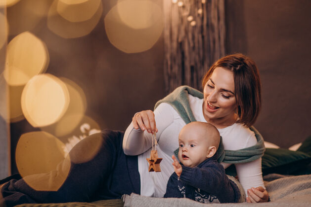 肖像妈妈带着她的男婴庆祝圣诞节圣诞装饰妈妈现代