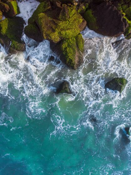 波垂直俯视空中拍摄的波浪蓝色的海洋对岩石岩石Swoosh海岸
