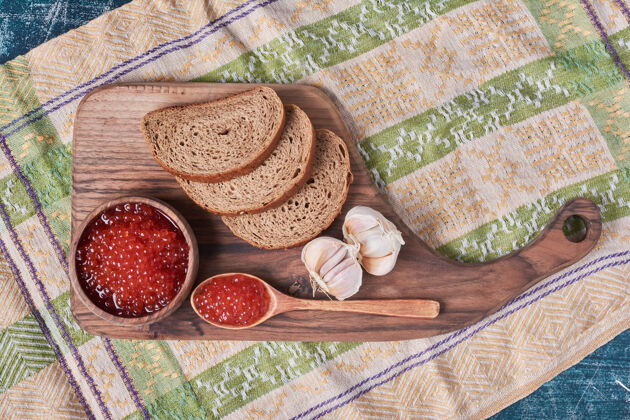 健康木板上的红鱼子酱配面包质量食品传统