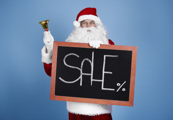 圣诞老人圣诞老人拿着黑板和铃铛的画像商业标志销售零售