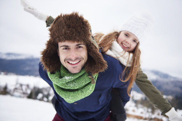 冬季爸爸和女儿在外面玩得开心向上积极季节