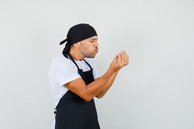 工作面包师穿着t恤 围裙上有意大利式的手势和撅嘴的嘴唇职业职业厨师