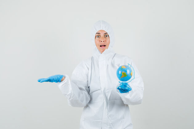 疾病女医生手拿地球仪 手放在一边 穿着防护服年轻人地球仪快乐