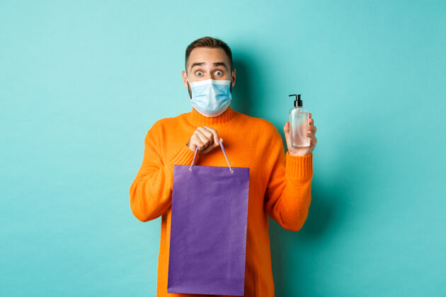 胡须冠状病毒 大流行和生活方式的概念人在面具显示购物袋和洗手液人物帅哥男人