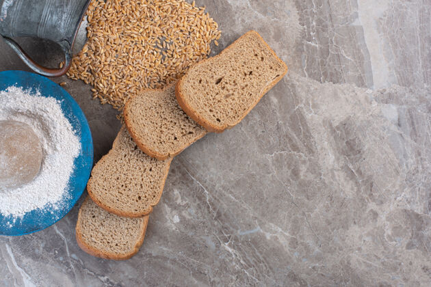 酵母一捆面包片 面粉拼盘和洒在大理石上的小麦罐面包盘子面粉